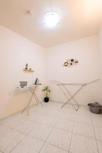 a white room with a glass table and a plant at The Calm City Escape in Heraklio +29 photos