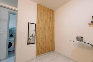 a hallway with a wooden door in a house at The Calm City Escape in Heraklio