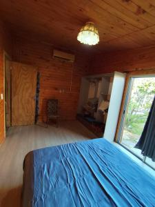 a bedroom with a bed and a large window at Maranata House in Xuí +5 photos