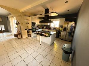 a large kitchen with a stove and a refrigerator at Villa Annaga in Saint-Paul +6 photos