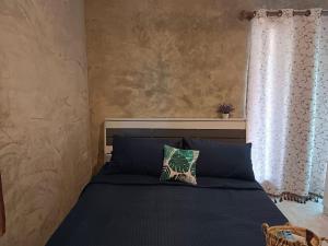 a bedroom with a blue bed with a window at Sunshine Rest Resort in Ubon Ratchathani