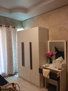 a white cabinet with a mirror and a table at Sunshine Rest Resort in Ubon Ratchathani +17 photos
