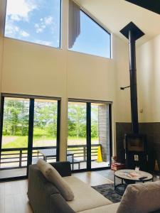 a living room with a couch and a fireplace at Kinagashi Happo Chalet East in Hakuba