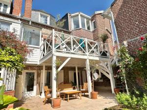 a house with a patio with a white deck at Villa Ancestor - Etretat in Étretat