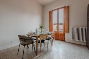 a dining room with a table and chairs and a window at Casa Altini in San Miniato +38 photos