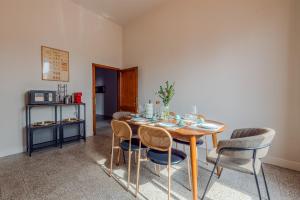 a dining room with a wooden table and chairs at Casa Altini in San Miniato