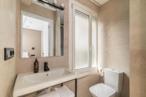 a bathroom with a sink and a toilet and a mirror at LEE Hotel in Andorra la Vella +17 photos