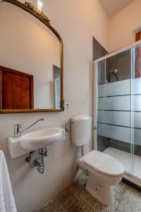 a bathroom with a toilet and a sink and a mirror at Casa Altini in San Miniato