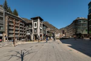 an empty street in a city with tall buildings at LEE Hotel in Andorra la Vella