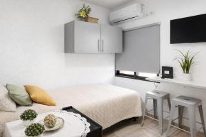 a small room with a bed and a table with stools at Departamento Moderno, equipado en Vicente Lopez , Ideal River Plate ,Tecnópolis ,100 metros del tren in Vicente López
