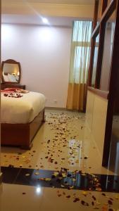 a bedroom with a bed and a floor covered in confetti at C Fun Addis Hotel in Addis Ababa