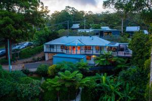 an aerial view of a house with a blue roof at Cloud 9 Eagle Heights - Cliff-Top, Ocean Sunrise, VIP Retreat in Mount Tamborine