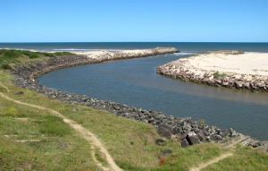 a river with rocks and the ocean in the background at Maranata House in Xuí