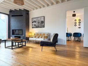 a living room with a couch and a table at Villa Ancestor - Etretat in Étretat
