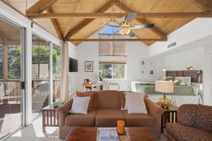 a living room with a couch and a ceiling fan at Desert Escape with Private Balcony condo in Indian Wells
