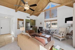 a living room with a couch and a ceiling fan at Desert Escape with Private Balcony condo in Indian Wells +26 photos