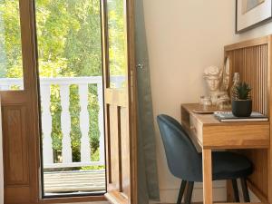 a desk with a chair next to a window at Villa Ancestor - Etretat in Étretat