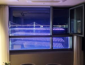 a window with a view of a bridge at night at 오늘도광안씨 in Busan