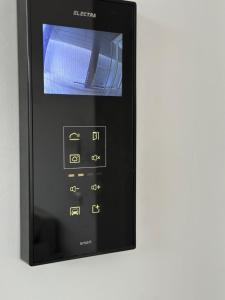 a remote control is shown on a white background at Warm Apartment 1 in Bucharest