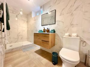 a white bathroom with a toilet and a tub at Villa Ancestor - Etretat in Étretat +38 photos