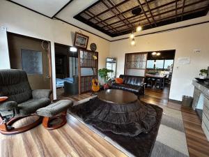 a living room with a couch and a table at Kominka engawa in Kakamigahara