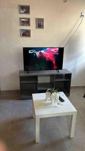 a living room with a tv and a white coffee table at Casa Altita Accommodation in Zacatlán