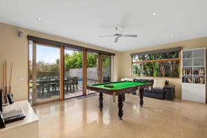 a living room with a pool table in it at Kingsley in Point Lonsdale