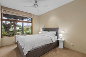 a bedroom with a large bed and a window at Kingsley in Point Lonsdale +22 photos
