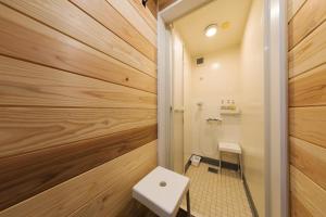 a bathroom with wooden walls and a toilet at 杜の酵素808 in Takaharu +37 photos