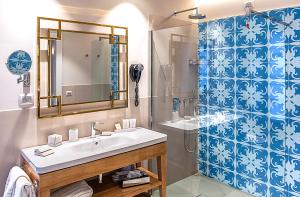 a bathroom with a shower, sink, and mirror at Hotel San Michele in Trapani