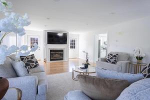 a living room with two couches and a fireplace at Charming Home for a Perfect Escape in East Hampton