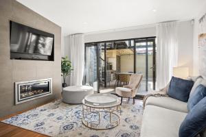 a living room with a couch and a fireplace at Albertine House in Melbourne