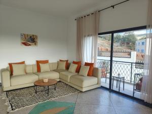 a living room with a couch and a balcony at Apartment amina in Azrou