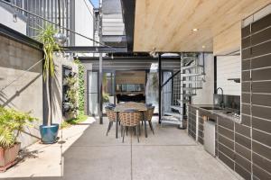 an outdoor patio with a table and chairs at Albertine House in Melbourne