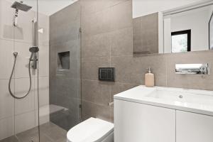 a bathroom with a shower and a toilet and a sink at Albertine House in Melbourne +11 photos