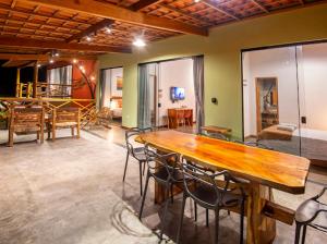 a large room with a wooden table and chairs at Chalé Lar do Capão in Vale do Capao
