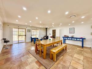 a large living room with a wooden table and chairs at Marrangaroo Meadows in Marrangaroo