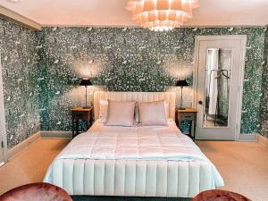 a bedroom with a white bed and green wallpaper at Buttonwood Hotel 1 - Boutique Accommodations in Cape May
