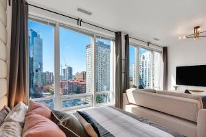 a living room with a large window with a city view at City Centre Studio - Best Location! in Vancouver