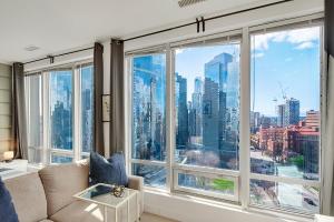 a living room with a large window with a view of the city at City Centre Studio - Best Location! in Vancouver