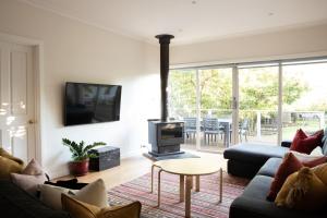 a living room with a couch and a fireplace at Clara Luce` in Bright