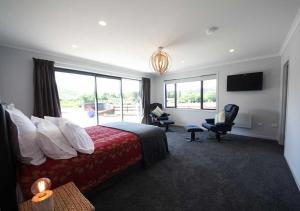 a hotel room with a bed and a large window at Mata-au Lodge in Beaumont