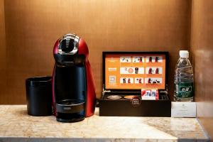 a coffee maker sitting on a counter next to a box at Hotel Nikko Xiamen in Xiamen