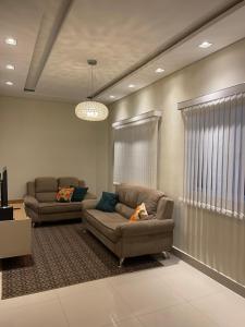 a living room with two couches and a couch at Lilly Queen I in Londrina
