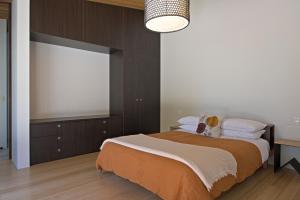 a bedroom with a bed and a large window at Hot Water Beach Bure Wera in Hotwater Beach