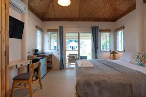 a bedroom with a large bed and a desk with a sink at The Hidden Lagoon in Rawai Beach +138 photos