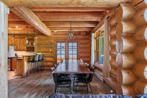 a dining room with a table and chairs in a log cabin at Fiddler Lake Resort - Moose 46 in Mille-Isles