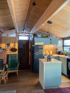 a kitchen with a refrigerator and a table in it at Original Trybo Cabin At Trysil Mountain in Trysil