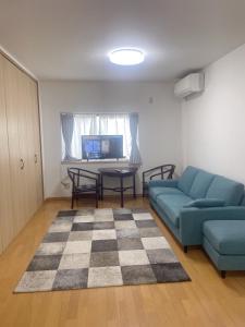 a living room with a couch and a table at 桃谷民宿 in Osaka