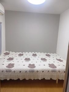 a bedroom with a bed with a hello kitty blanket at 桃谷民宿 in Osaka